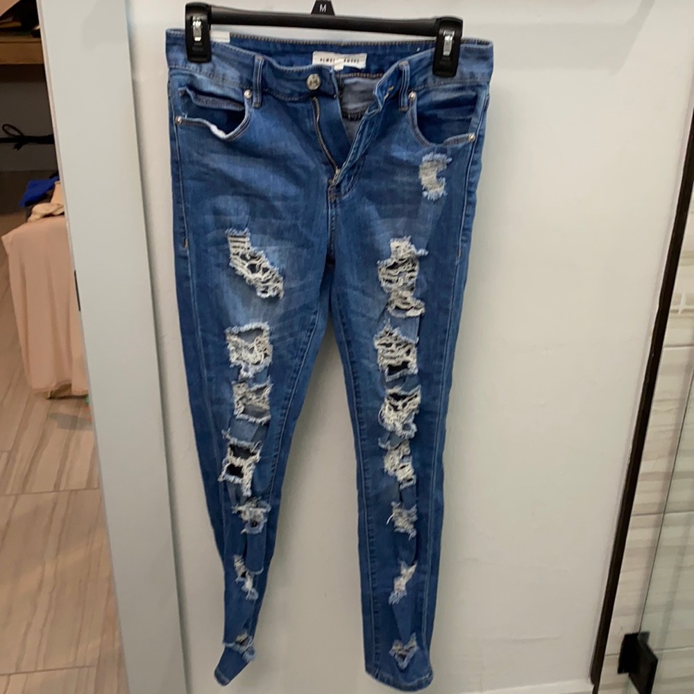 WORN size 5 jeans. Lots of rips throughout the leg. Skinny.